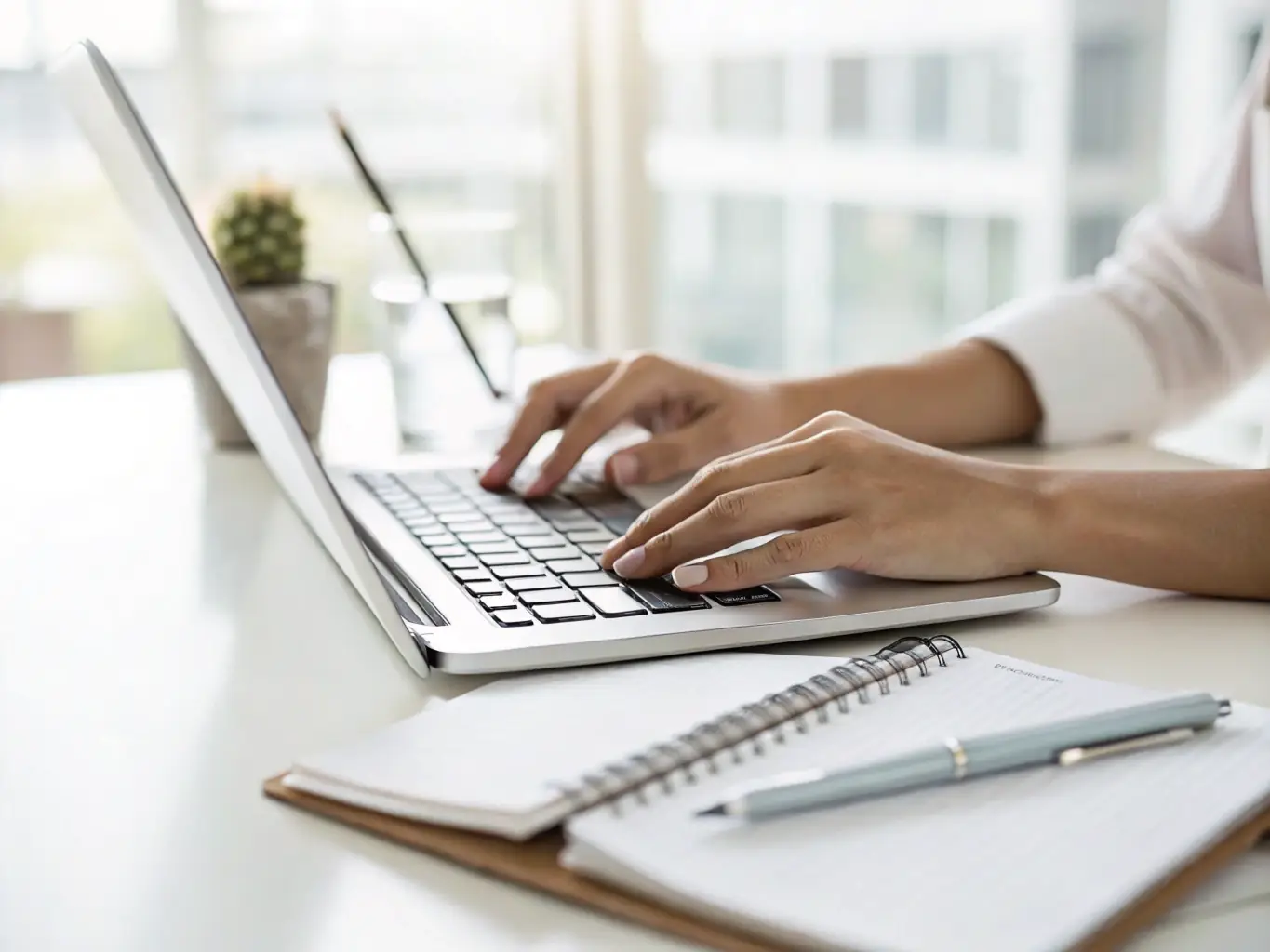 A person typing on a laptop, composing an email, with the balanceLAB.3D logo subtly visible in the background, representing digital communication.